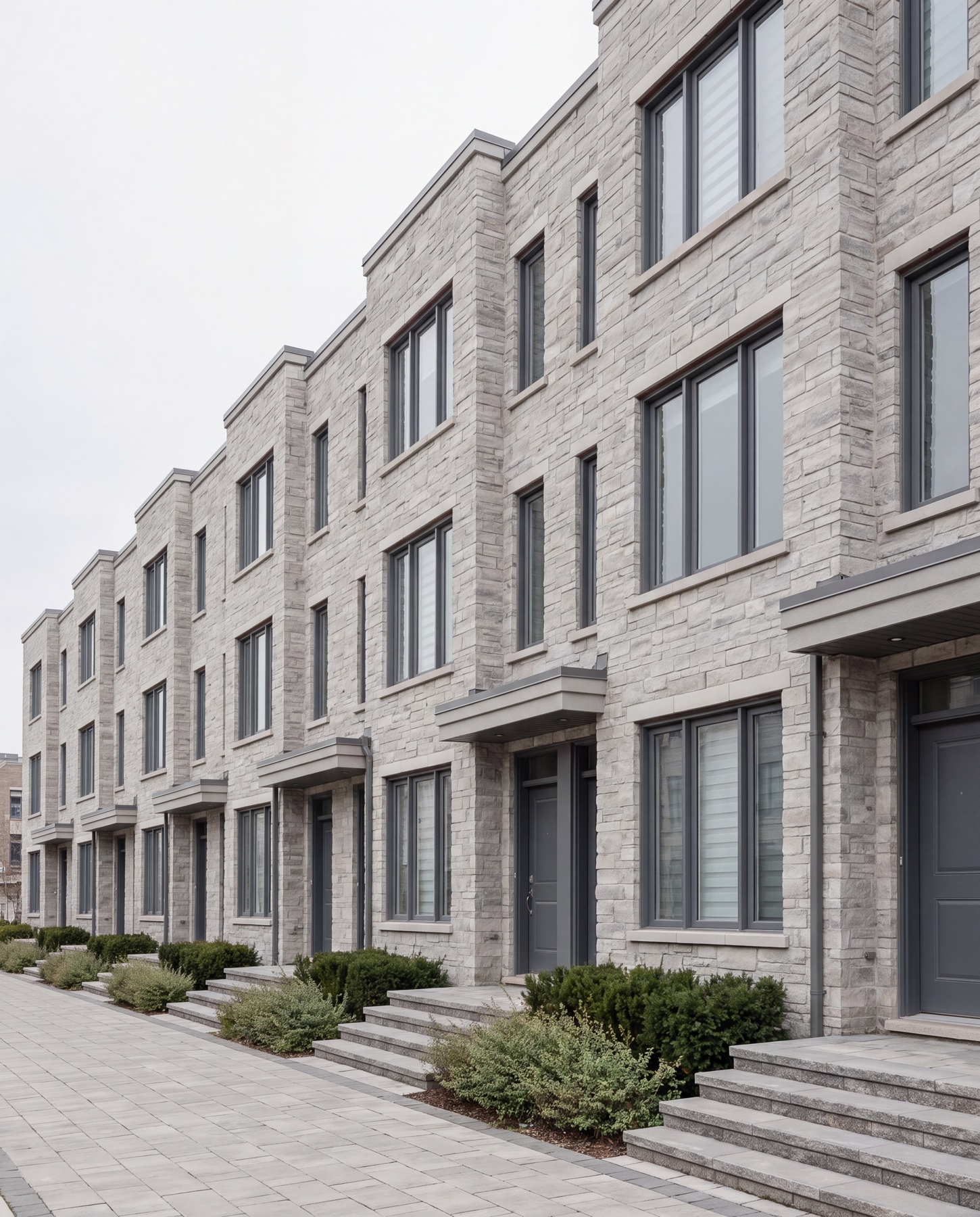 Repeated townhome frontages in an Ontario development where the same Crown stone runs across every unit.