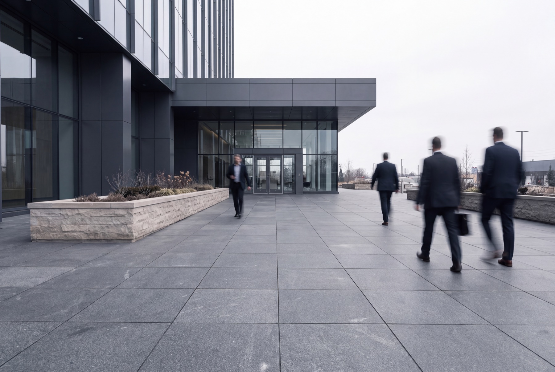 A wide, level Black Pearl granite entrance plaza serving steady foot traffic.